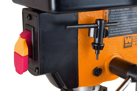 Close-up of 2.3-Amp 8-Inch Cast-Iron Benchtop Drill Press With 5 Speed Settings, Black and Orange body, showing chuck storage.