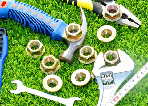 Heavy Duty Hex Flanged Spindle Blade Nuts Engineered For Slick Hella Smooth Operation On Cub Cadet Mtd Toro And Troy Bilt Zero Turn Mowers Providing Killer 5/8 Inch 18 Thread Fitment Two Pack on grass with tools.