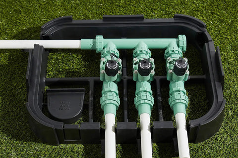 Heavy Duty 3 Valve Preassembled Irrigation Manifold with Swivel Unions installed in garden on artificial grass