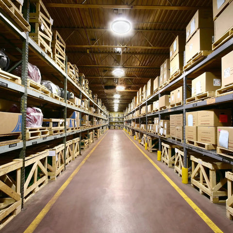 Industrial warehouse lit by 150W LED High Bay Lights 4 Pack UFO 6000K Daylight, 22,500 Lumens, 5Ft Cable With Plug, Energy Saving.
