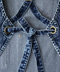 Close-up of Denim Apron For Men With Towel Loop And Tool Pockets, adjustable blue-black straps and brass rings, 100% cotton, special washed style.