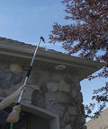 Person using Telescoping Gutter Cleaning Wand With 40 To 70 Inch Reach Rotating 180 Degree Nozzle Four Position Head Durable Silver Finish