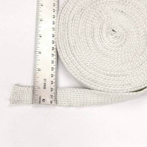 Lynn Manufacturing high-temperature flat gasket tape, white, 1in x 1/8in x 25ft, coiled roll beside ruler