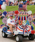 Patriotic golf cart decorated with All In One 4th Of July Golf Cart Decor Kit For Parades And Independence Day Patriotic Banner Tassel Garlands Fringe Curtains Star Garlands Paper Pompoms And Flag Balloons To Deck Out Your Ride.