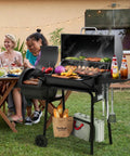 Smokin Hot Charcoal Grill With Offset Smoker For Outdoor Cooking 823 Sq In Total Surface with food grilling next to a table.