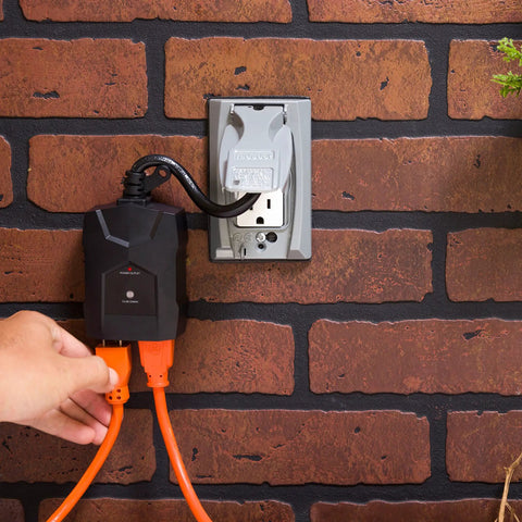 No Fuss Outdoor Dusk To Dawn Light Timer Featuring Dual Power Outlets And Integrated Photocell Sensor For Absolutely Hands Free Weather Resistant Lighting Setup plugged into a wall outlet with orange extension cords.