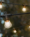 Backyard Bistro Style 24 Foot Outdoor String Lights With 12 Shatter Resistant Lifetime Bulbs, 2200K Warm White in garden setting