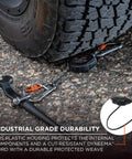 Squids 3011 Retractable Tool Lanyard With Carabiner Mount under truck tire with wrench, showcases industrial grade durability.