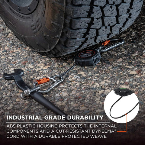 Squids 3011 Retractable Tool Lanyard With Carabiner Mount under truck tire with wrench, showcases industrial grade durability.