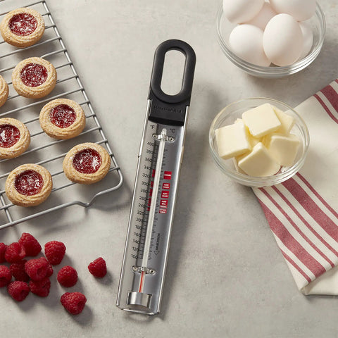 Curved Candy And Deep Fry Thermometer With Pro Grade Stainless Steel Paddle for Easy Stirring on kitchen counter