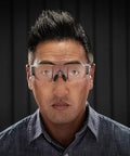 Legit Heavy Duty Safety Glasses Featuring Self Adjusting Flex Temples And Shatter Proof Clear Lenses Crafted For High Cheekbones Plus No Hassle All Day Comfort worn by a man with dark hair, highlighting anti-fog features.