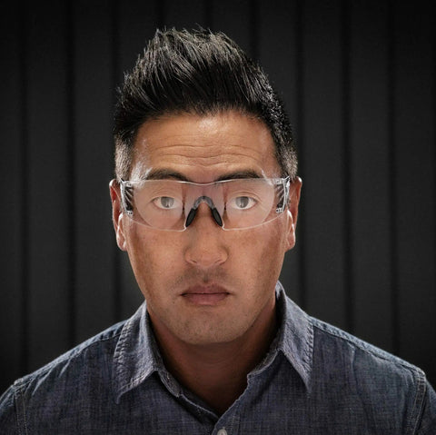 Legit Heavy Duty Safety Glasses Featuring Self Adjusting Flex Temples And Shatter Proof Clear Lenses Crafted For High Cheekbones Plus No Hassle All Day Comfort worn by a man with dark hair, highlighting anti-fog features.
