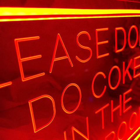 Close-up of "Please Dont Do Coke In The Bathroom Neon Sign For Wall Decor 3D Art Carving LED Light" with red lettering on acrylic.