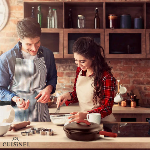 Couple cooking in kitchen with 12 Inch Cast Iron Skillet With Lid on stove, silicone handle visible on cookware.