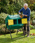 Man using 43 Gallon Dual Chamber Compost Tumbler With Gloves, Fast Assembly And Easy Setup For Outdoor Use, Garden Kitchen Yard Bin Green.