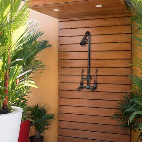 Outdoor Shower Kit With Soap Dish, Matte Black Finish, Corrosion And Rust Resistant, mounted on wooden panel in patio