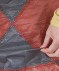 Applying Seam Grip WP Waterproof Sealant And Adhesive For Jackets Tents Tarps Rain Gear And Outdoor Fabric on a tarp seam