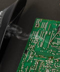 ZeroSmog EL Portable Fume Extraction Unit shown extracting solder smoke during circuit board assembly, close-up view.