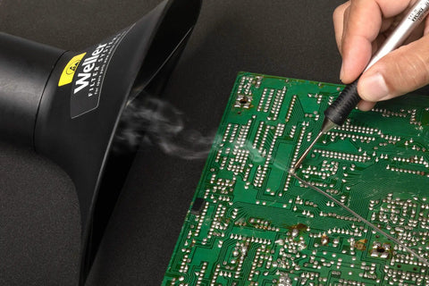 ZeroSmog EL Portable Fume Extraction Unit shown extracting solder smoke during circuit board assembly, close-up view.