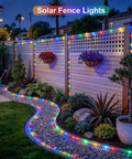 Outdoor 200 LED Solar Rope Lights, 66ft IP65 Waterproof Trampoline and Garden Decor illuminating a garden fence at night.