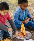 Kids playing with Campfire S'mores Pretend Play Set With 23-Piece Toy Food Kit For Kids 3 Plus, including logs and marshmallows.