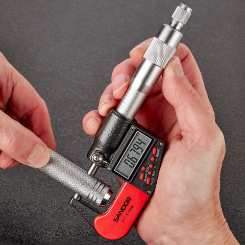 Person using Digital Outside Micrometer With Carbide Tip For Precise Measurements 0 To 1 Inch And 0 To 25 Mm Range With 0.00005 Inch And 0.001 Mm Accuracy Ratchet Stop And Protective Case Pro Grade Machinist Workshop Tool