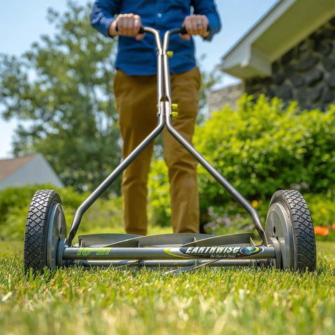 Person using a 16-Inch 7-Blade Push Reel Lawn Mower with Ball Bearing Reel and 10-Inch Composite Wheels, durable steel side plate.