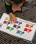 Child learning to count in the Totally Rad Toddler Counting Book Featuring Ten Noisy Rickshaws and Hella Fun Indian Culture.