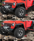 48 Inch Heavy Duty Farm Jack With 7000 Lb Lifting Capacity in use lifting a red SUV bumper over rocky terrain