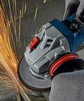 Heavy Duty 4 Inch Angle Grinder With Slick Paddle Switch And Lockdown Ergonomic Handle For Tough Metal Cutting And Grinding Duties Requiring Hardcore Torque And All Day Easy On The Hands Control in action, generating sparks.