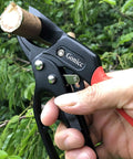 Badass Heavy Duty Anvil Pruning Shears 8 Inch Blade Ratchet Action Pruner For Rose Bushes in hand cutting a branch.