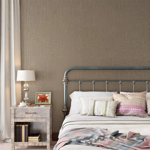 Taupe Metallic Grasscloth Peel And Stick Wallpaper Roll Featuring Faux Woven Texture With Subtle Shimmer in cozy bedroom setting.