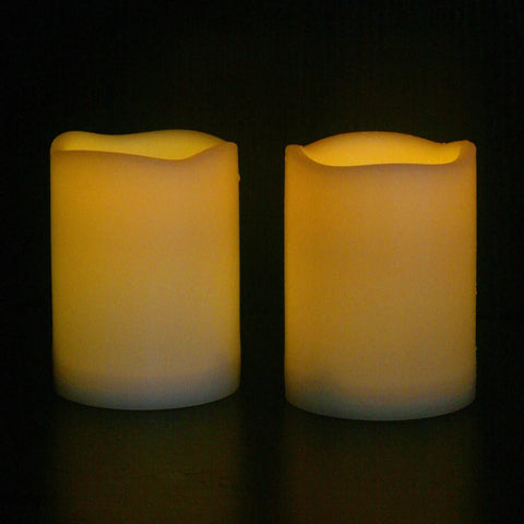 Waterproof Outdoor LED Flameless Candles with Remote, 3x4 inches, white plastic pillars with warm flicker, shown in dim lighting.