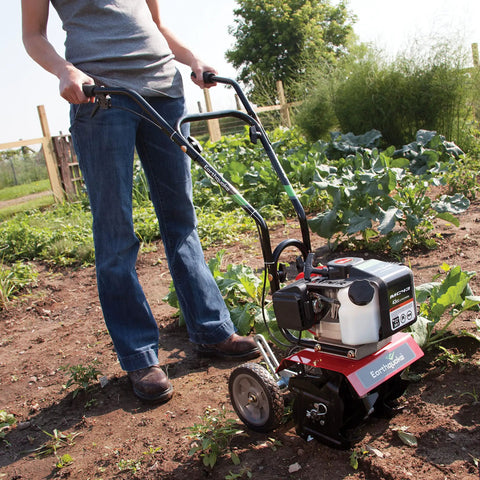 Gardener using Cultivator With 43Cc 2 Cycle Viper Engine 6 To 10 Inch Adjustable Width 8 Inch Maximum Depth on soil