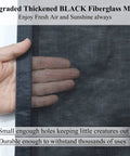 Close-up of hand touching upgraded thickened black fiberglass mesh of the Tall Magnetic Screen Door Upgrade With 42 Strong Magnets For 38x98 Retractable Fiberglass Mesh Heavy Duty Closure Hands Free Automatic Seal For Single Door.