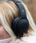 Person wearing Crusher Evo Wireless Bluetooth Headphones With Dope Multi Sensory Bass, Noise Isolating Over Ear Fit, True Black