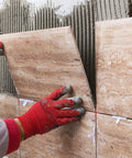 Honoson tile spacer set, 1/16 in, 500 pieces; white cross spacers shown between beige stone-look wall tiles.