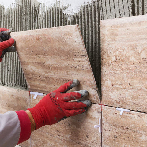 Honoson tile spacer set, 1/16 in, 500 pieces; white cross spacers shown between beige stone-look wall tiles.
