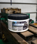 Lith Ease White Lithium Grease 16 Oz Tub on workbench for heavy duty metal lubrication and rust protection
