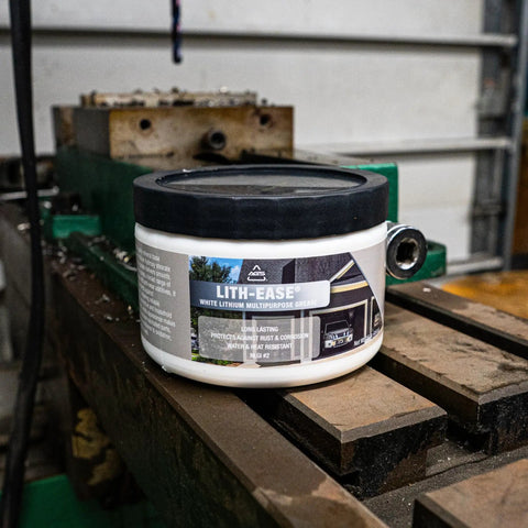 Lith Ease White Lithium Grease 16 Oz Tub on workbench for heavy duty metal lubrication and rust protection