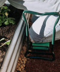Person using the 2-In-1 Garden Kneeler And Seat With Cushioned Pad, Foldable Stool for weeding next to garden bed