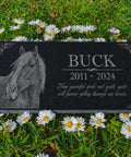 Black granite Custom Horse Memorial Stone For Garden And Grave Marker with horse image and engraving on grass.