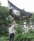 Man holding Ultra Lightweight 2 Person Backpacking Tent With Aluminum Poles Waterproof Rainfly For Hiking And Camping Army Green