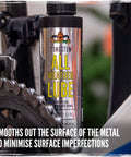 Close-up of BananaSlip Tungsten All Weather Lube in 50ml bottle next to bike chain, for smooth shifts on road mountain e-bike rides.