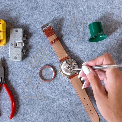 Person working on a watch with tools, using Must-Have 360 Piece Stainless Steel Watch Band Pins Kit With 18 Sizes From 6mm To 23mm for repairs.