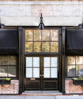 Shopfront with Outdoor Aluminum Barn Light In Glossy Black With Gooseneck Arm 16 Inch Wet Location Rated Classic Barn Style Shade