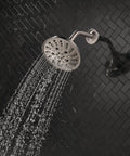 H2Okinetic Rain Shower Head With Five Settings In Stainless Finish Touch Clean Nozzle System spraying water in bathroom