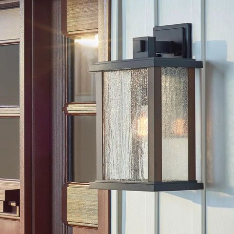 Outdoor Wall Light Sconce In A Sleek Dope Black Finish With Clear Seeded Glass, 17 Inches High By 10 Inches Wide, mounted on wall