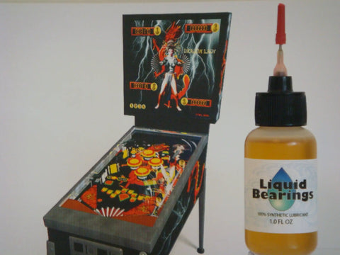 100 Percent Synthetic HO Slot Car Oil That Displaces Old Oils And Boosts Speed, with needles, shown next to pinball machine
