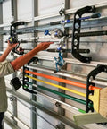 Person organizing rods on Garage Door Storage Rack for Fishing Gear 21 Inch Black ABS Rod Holder Lets You Hook Up Saltwater Tackle Fast